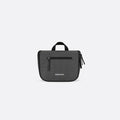 A Sherpani Co-Pilot Granite Travel Toiletry Case, front view showing handheld strap and zipper pockets on white backdrop. #color_granite-grey