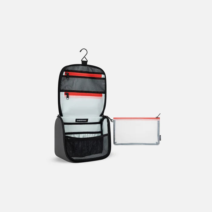 A Sherpani Co-Pilot Granite Travel Toiletry Case, 3/4 view showing interior pockets  against white backdrop. #color_granite-grey