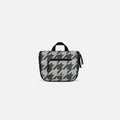 A Sherpani Co-Pilot Houndstooth Travel Toiletry Case, 3/4 view showing interior pockets  against white backdrop. #color_houndstooth-print
