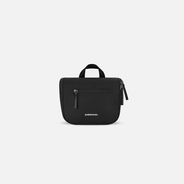 A Sherpani Co-Pilot Carbon Black Travel Toiletry Case, front view showing handheld strap and zipper pockets on white backdrop. #color_carbon-black