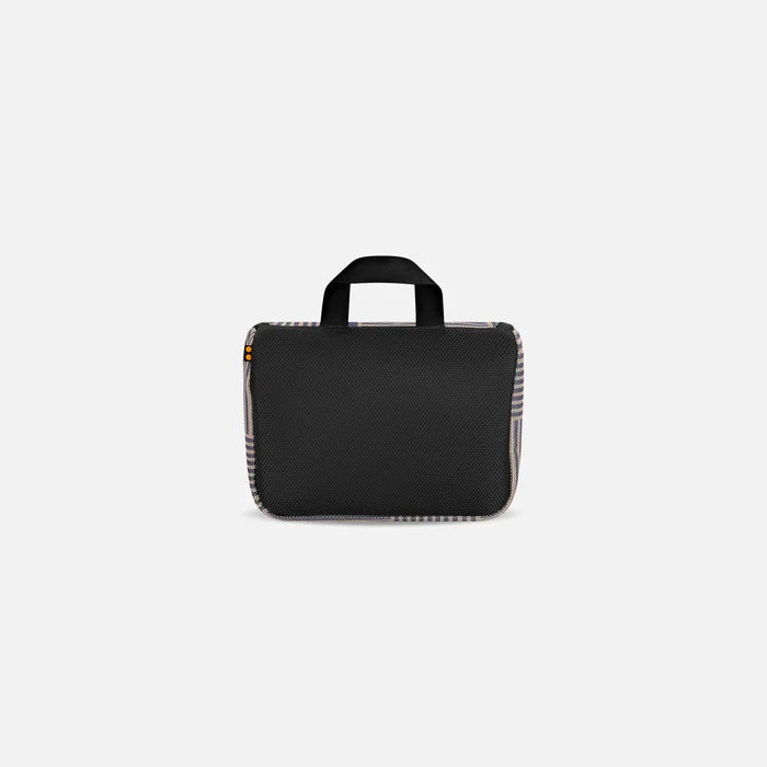 A Sherpani Co-Pilot Smoky Orchid Travel Toiletry Case, back view showing black backside on white backdrop. #color_passport-print