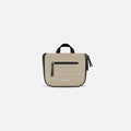 A Sherpani Co-Pilot Straw Beige Travel Toiletry Case, front view showing pockets and handle against white background.  #color_straw-beige