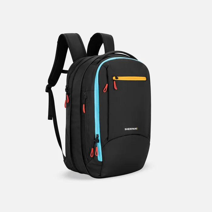 A Sherpani Crew Chromatic Black Travel Backpack, 3/4 view showing lockable zippers and the extender pocket against a white background #color_chromatic-black