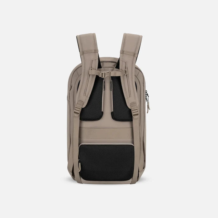 A Sherpani Crew Dune Travel Backpack, back view showing back strap pockets and shoulder straps against a white background.  #color_dune-tan
