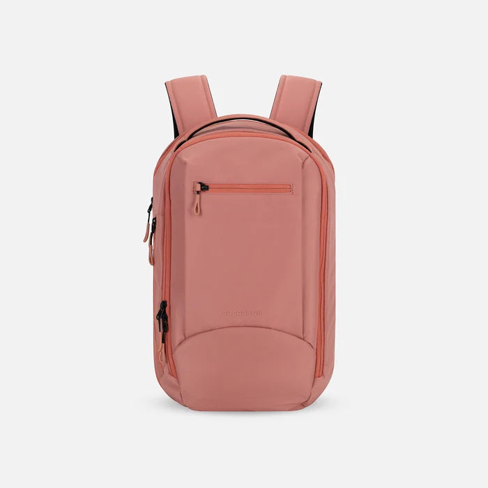 A Sherpani Crew Desert Pink Travel Backpack, front view showing lockable zippers and different straps against a white background. #color_desert-pink