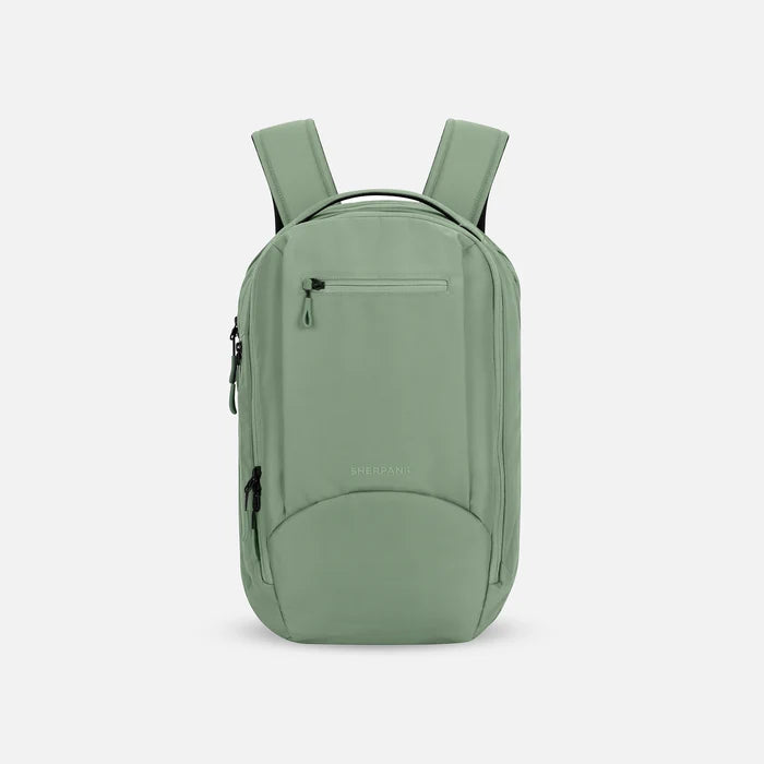 A Sherpani Crew Olivine Travel Backpack, front view showing lockable zippers and different straps against a white background. #color_olivine-green