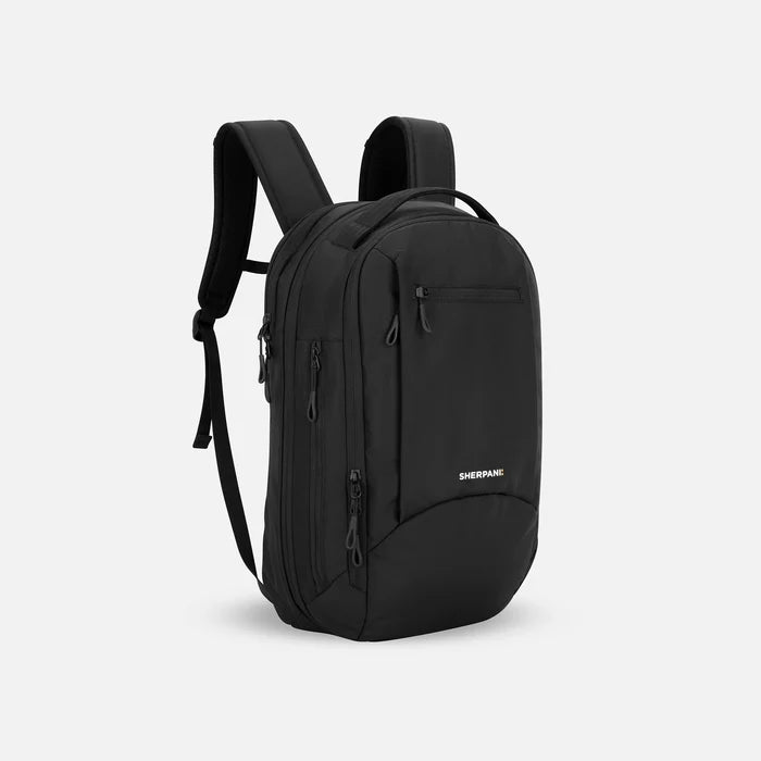 A Sherpani Crew Raven Black Travel Backpack, 3/4 view showing lockable zippers and different straps against a white background. #color_raven-black
