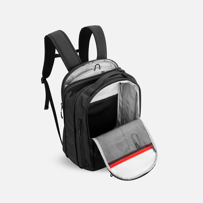 A Sherpani Crew Raven Black Travel Backpack, above view showing inside main and laptop pocket against a white background. #color_raven-black