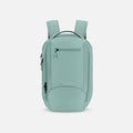 A Sherpani Crew Surf Blue Travel Backpack, front view showing lockable zippers and different straps against a white background. #color_surf-blue