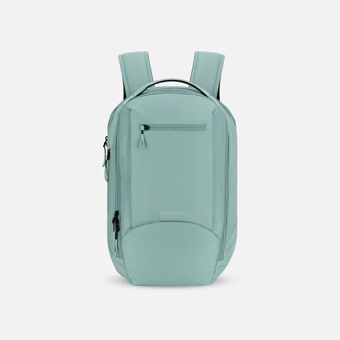 A Sherpani Crew Surf Blue Travel Backpack, front view showing lockable zippers and different straps against a white background. #color_surf-blue