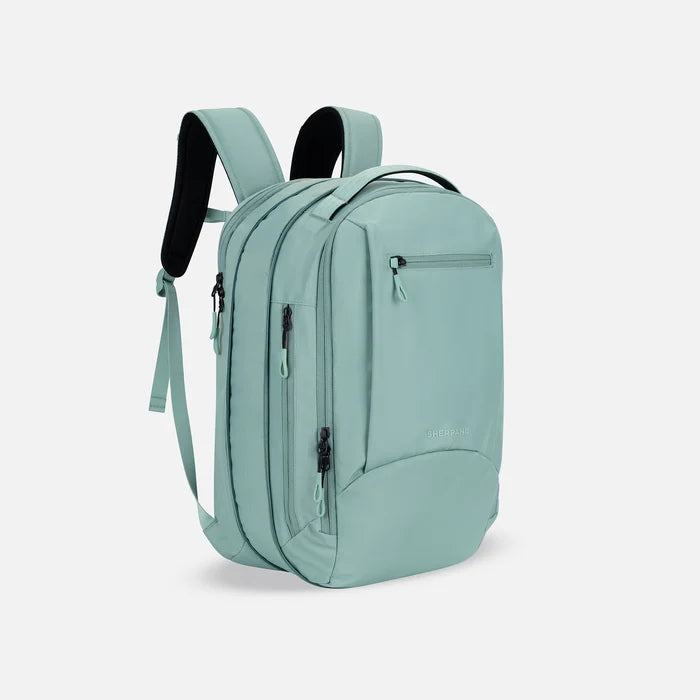 A Sherpani Crew Surf Blue Travel Backpack, 3/4 view showing lockable zippers and the extender pocket against a white background #color_surf-blue