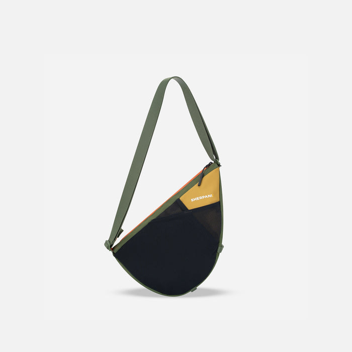 A Sherpani Cross Link Antelope Adventure Sling, front view showing front mesh pocket on white backdrop.  #color_antelope