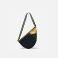 A Sherpani Cross Link Antelope Adventure Sling, front view showing front mesh pocket on white backdrop.  #color_antelope
