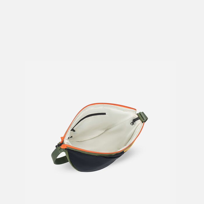 A Sherpani Cross Link Antelope Adventure Sling, above view showing inside main pocket on white backdrop.  #color_antelope