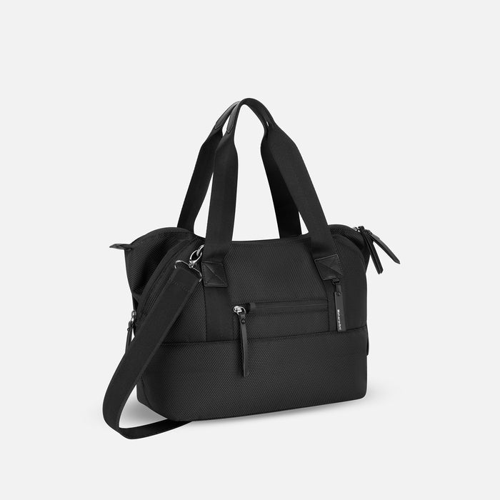 A Sherpani Eclipse Carbon Expandable Tote, 3/4 view showing lockable pocket & strap options on white backdrop. #color_carbon