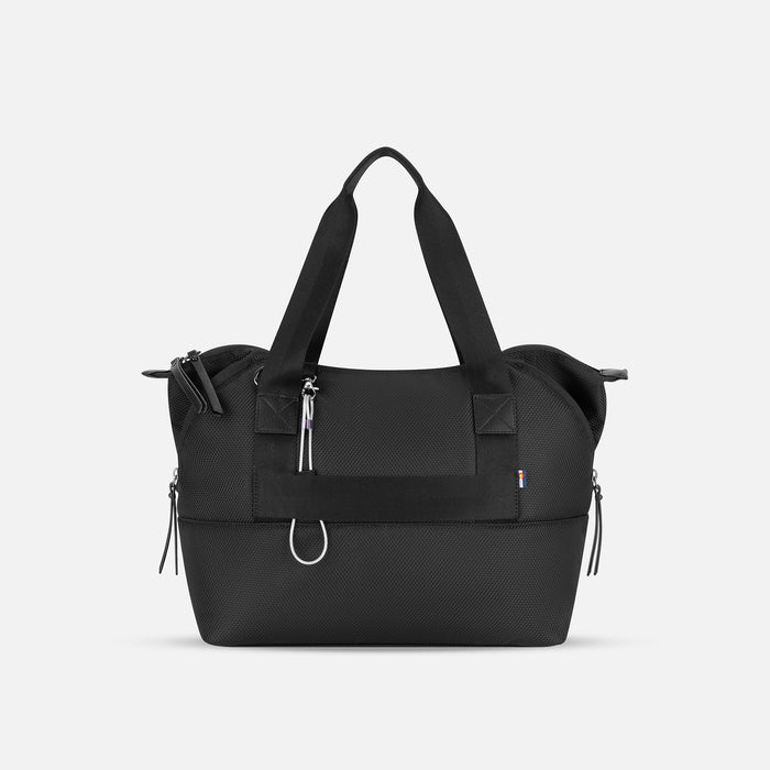 A Sherpani Eclipse Carbon Expandable Tote, back view showing the luggage strap & strap options on white backdrop. #color_carbon