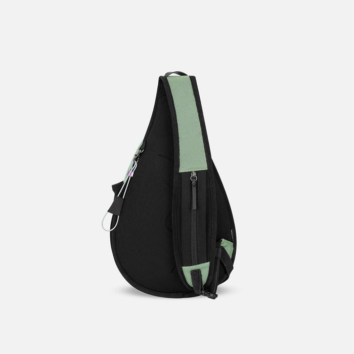A Sherpani Esprit Aloe Mist Green Anti-theft Sling Bag, back view showing the strap pocket and the chair lock on a white background. #color_aloe-mist-green