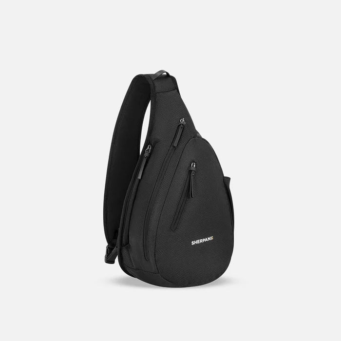 A Sherpani Esprit Carbon Black Anti-theft Sling, 3/4 view showing strap & lockable pockets on white backdrop. #color_carbon-black