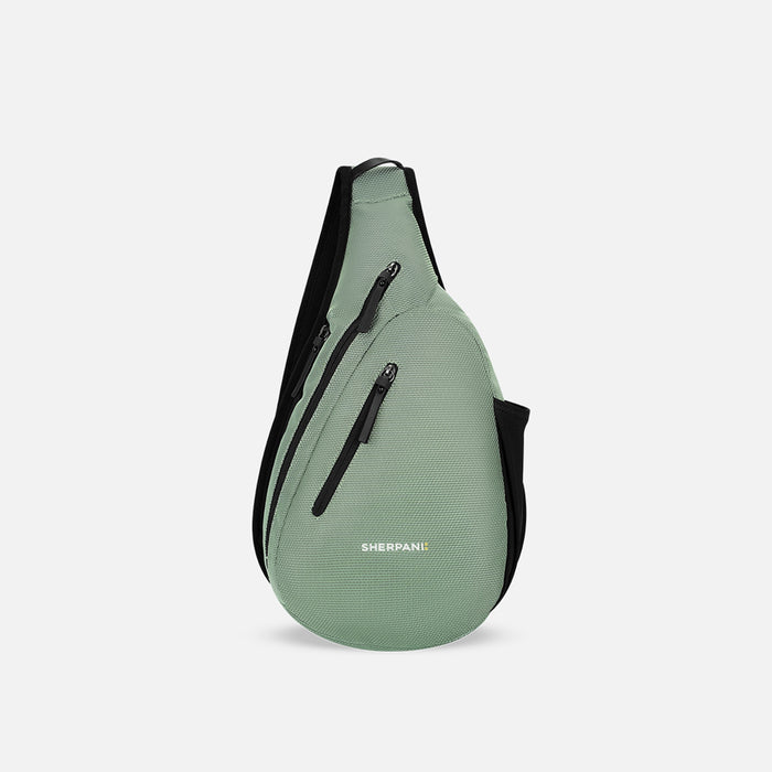 A Sherpani Esprit Aloe Mist Green Anti-theft Sling Bag, front view showing lockable pockets and main strap on a white background. #color_aloe-mist-green