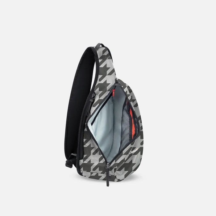 A Sherpani Esprit Houndstooth Anti-theft Sling, side view showing inside main pocket on white backdrop. #color_houndstooth-print