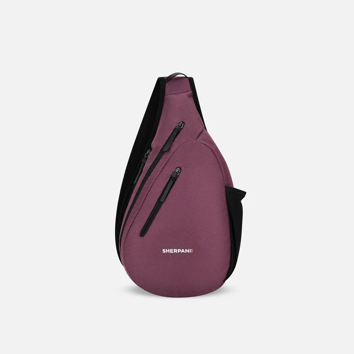 A Sherpani Esprit Smoky Orchid Anti-theft Sling, front view showing strap & lockable pockets on white backdrop. #color_smoky-orchid-pink