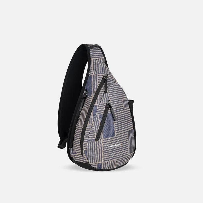 A Sherpani Esprit Passport Anti-theft Sling, 3/4 view showing strap & lockable pockets on white backdrop. #color_passport-print