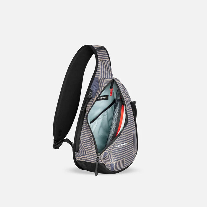 A Sherpani Esprit Passport Anti-theft Sling, side view showing inside main pocket on white backdrop. #color_passport-print
