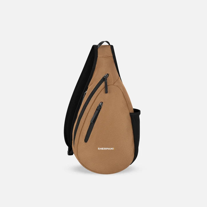 A Sherpani Esprit Sand Anti-theft Sling, front view showing strap & lockable pockets on white backdrop.  #color_sand-tan