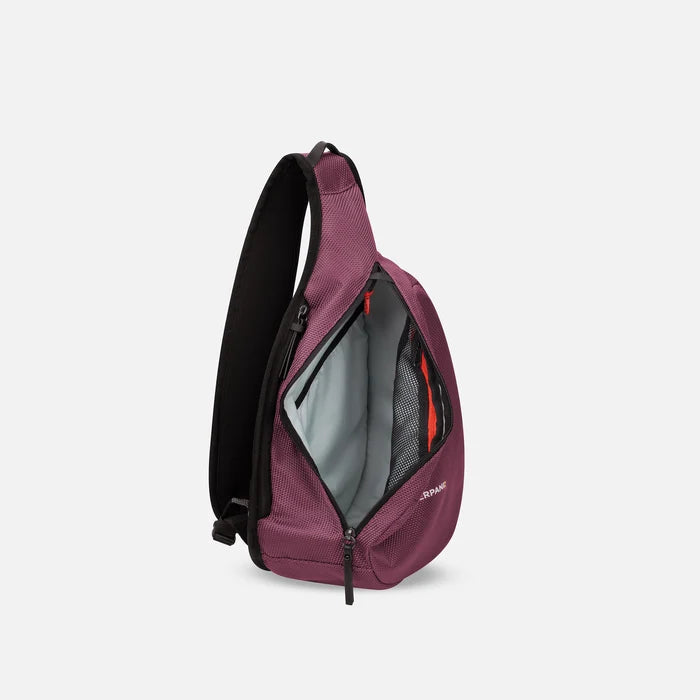 A Sherpani Esprit Smoky Orchid Anti-theft Sling, side view showing inside main pocket on white backdrop. #color_smoky-orchid-pink