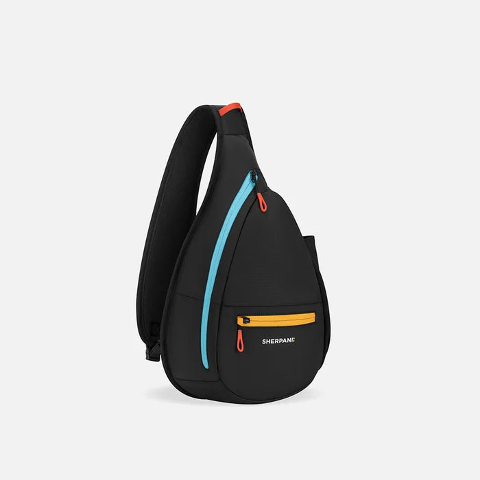 A Sherpani Esprit Chromatic Black Sling, 3/4 view showing strap & lockable pockets on white backdrop.  #color_chromatic-black