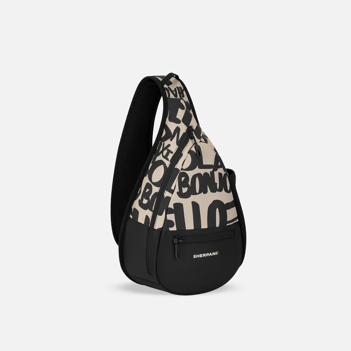 A Sherpani Esprit Ciao Sling, 3/4 view showing strap & lockable pockets on white backdrop.  #color_ciao-print