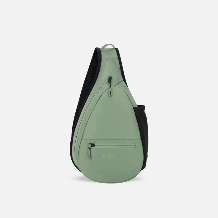 A Sherpani Esprit Olivine Sling, front view showing strap & lockable pockets on white backdrop.  #color_olivine-green