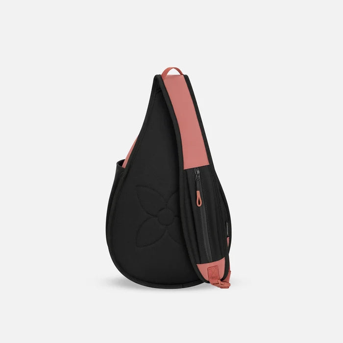 A Sherpani Esprit Desert Pink Sling Bag, back view showing the strap pocket and the chair lock on a white background.  #color_desert-pink