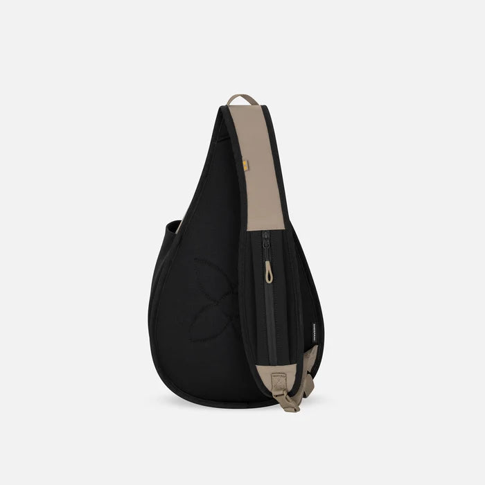 A Sherpani Esprit Dune Sling Bag, back view showing the strap pocket and the chair lock on a white background.  #color_dune-tan