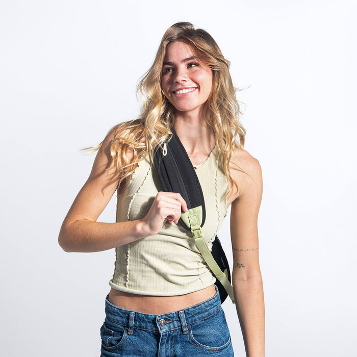 Woman wearing a Sherpani Esprit Palm Green Sling Bag against white background.  #color_palm-green
