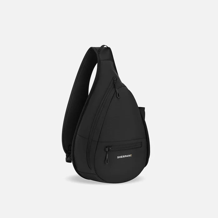 A Sherpani Esprit Raven Black Sling, 3/4 view showing strap & lockable pockets on white backdrop.  #color_raven-black