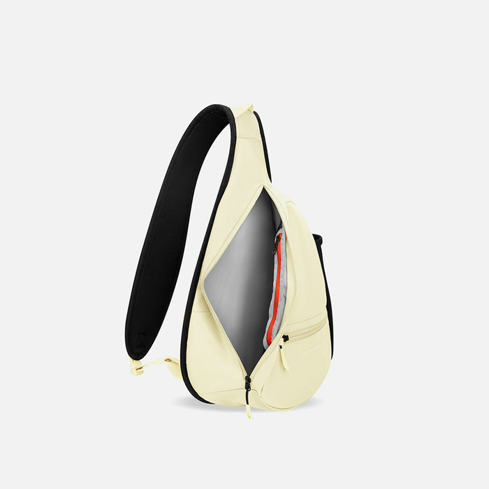 A Sherpani Esprit Sol Yellow Sling Bag, side view showing inside of main pocket with a sleeve on a white background.  #color_sol-yellow