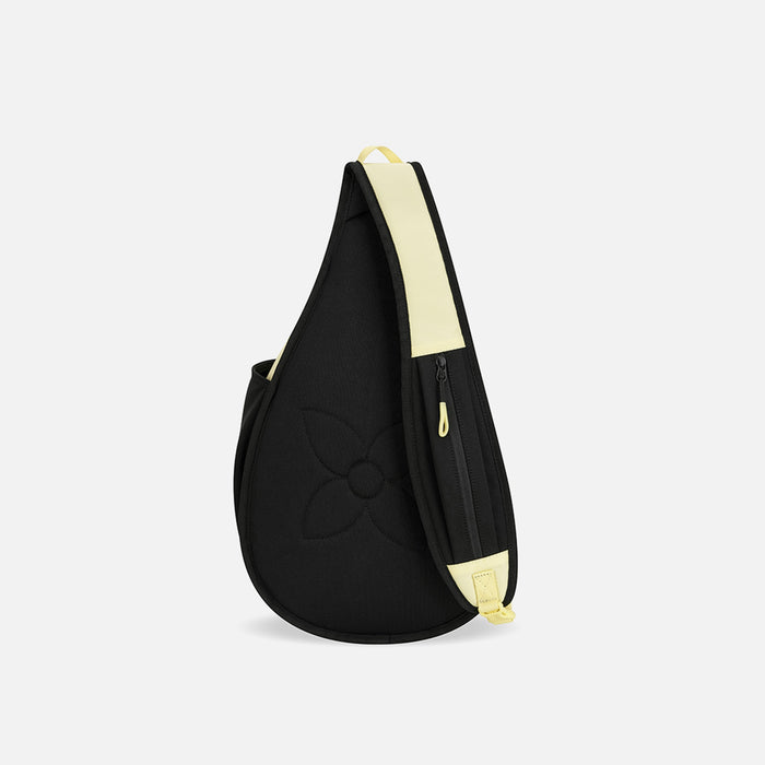 A Sherpani Esprit Sol Yellow Sling Bag, back view showing a pocket on the strap against a white background.   #color_sol-yellow