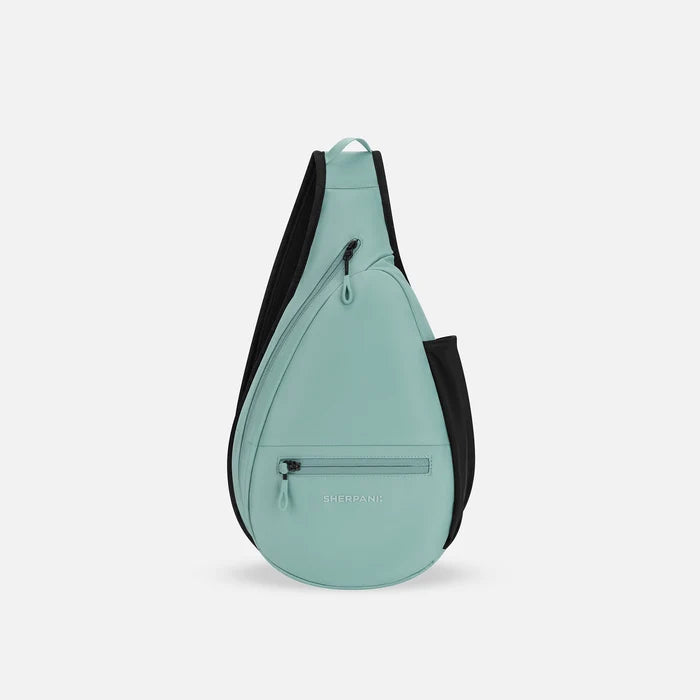 A Sherpani Esprit Surf Blue Sling, front view showing strap & lockable pockets on white backdrop.  #color_surf-blue