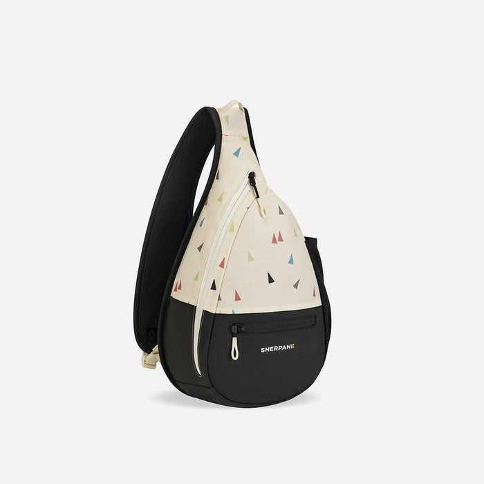 A Sherpani Esprit Terrazzo Print Sling Bag, 3/4 view showing two front pockets and the strap on a white background.  #color_terrazzo-print