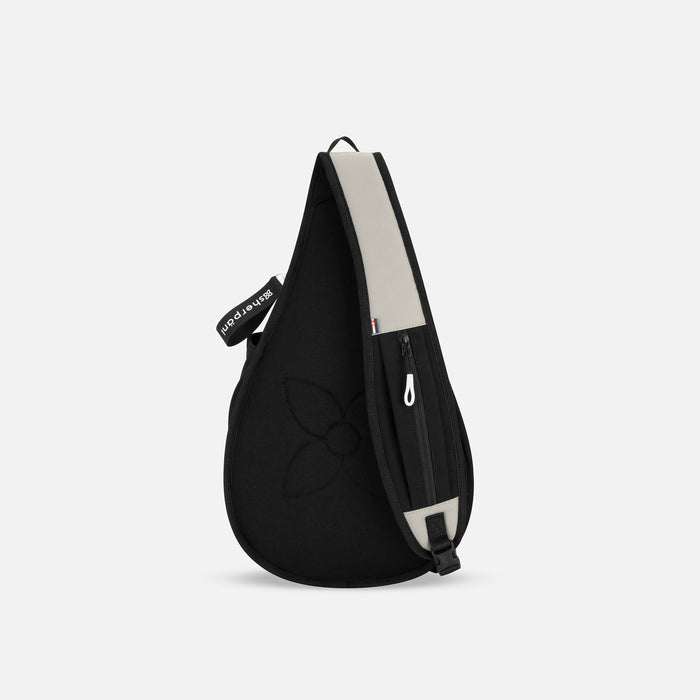 A Sherpani Esprit Wasabi Stone Sling Bag, back view showing the strap pocket on white background.  #color_wasabi-stone-heritage