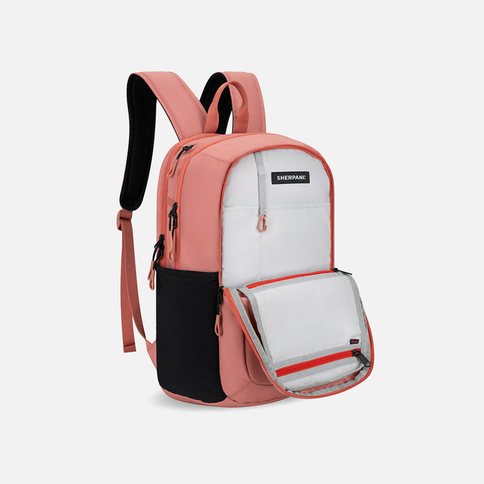 A Sherpani Getaway Desert Pink Travel Backpack, 3/4 showing inside a pocket on white backdrop. #color_desert-pink