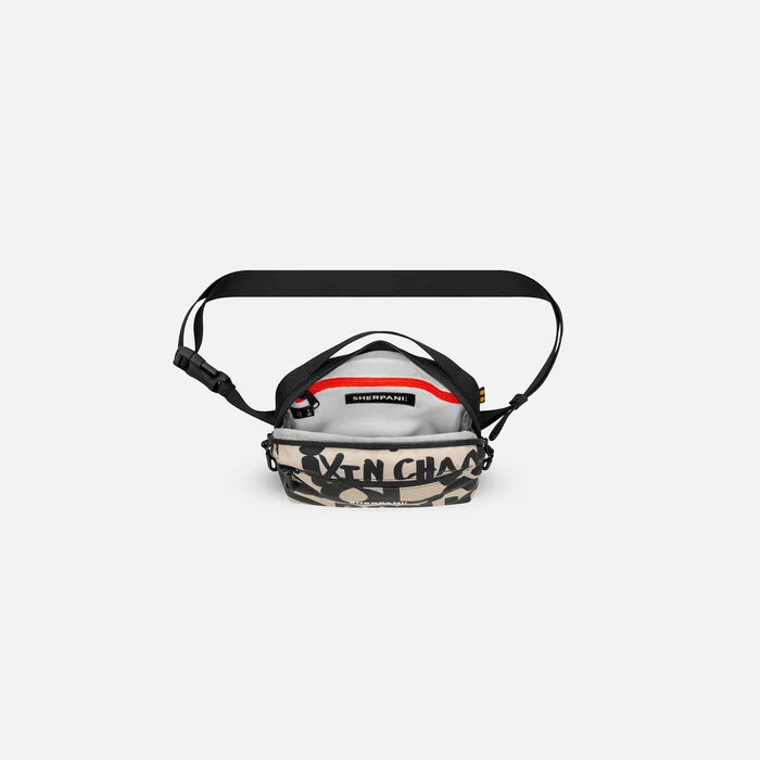 A Sherpani Hyk Ciao Hip Pack, above view showing inside of main pocket on white backdrop. #color_ciao-print