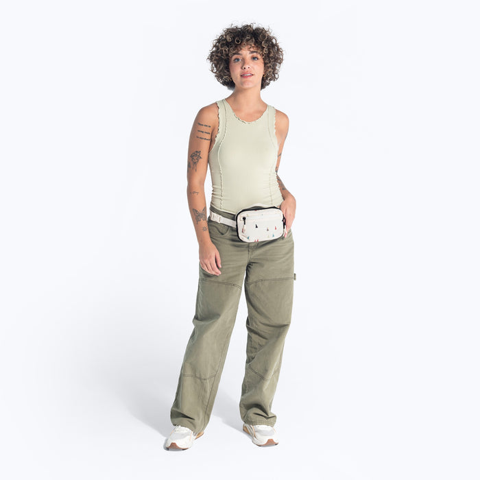 Woman wearing a Sherpani Hyk Terrazzo Print Hip Pac on her hip against white backdrop.  #color_terrazzo-print