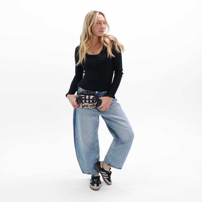 Woman wearing a Sherpani Hyk Ciao Hip Pack on her hip against white backdrop.   #color_ciao-print