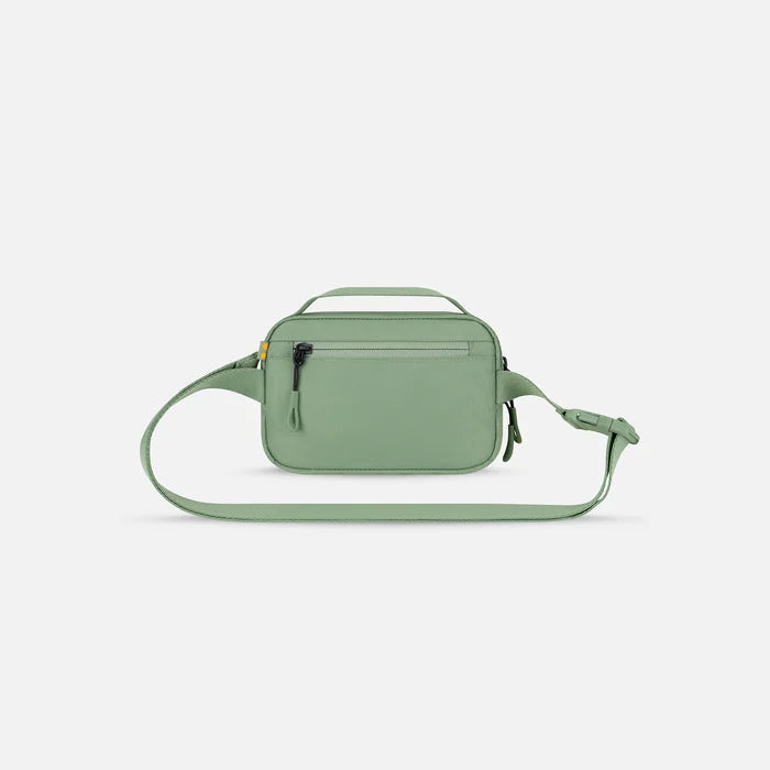A Sherpani Hyk Olivine Hip Pack, back view showing pocket and straps on white backdrop. #color_olivine-green