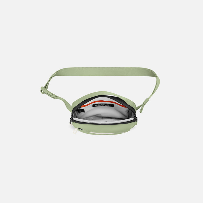 A Sherpani Hyk Palm Green Hip Pack, above view showing inside of main pocket on white backdrop. #color_palm-green