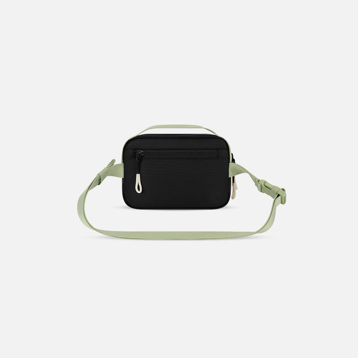 A Sherpani Hyk Palm Green Hip Pack, back view showing pocket and straps on white backdrop.  #color_palm-green