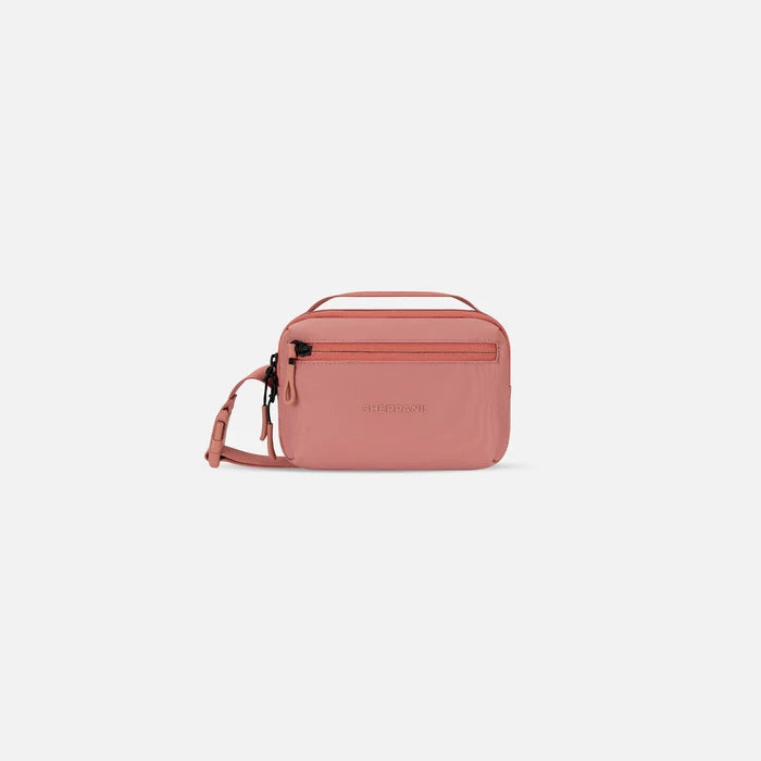 A Sherpani Hyk Ciao Hip Pack, front view showing pocket and straps on white backdrop.  #color_desert-pink