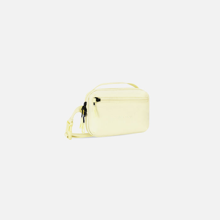 A Sherpani Hyk Sol Yellow Hip Pack, 3/4 view showing pocket and straps on white backdrop. #color_sol-yellow